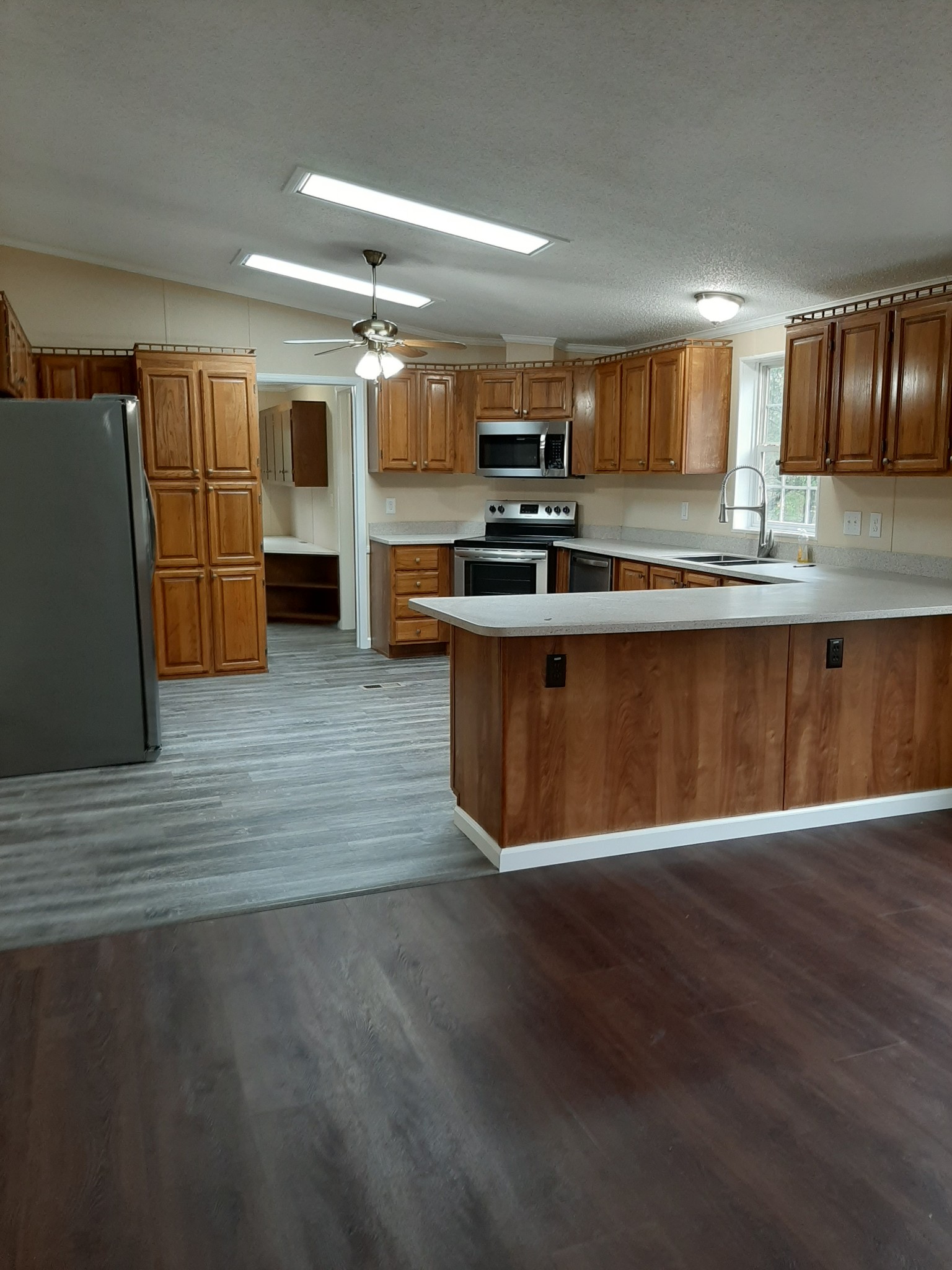 4354 Cainsville Road Lebanon, TN 37090 - Photo 11 of 26 a large kitchen with stainless steel appliances wooden floor a sink and a counter top space