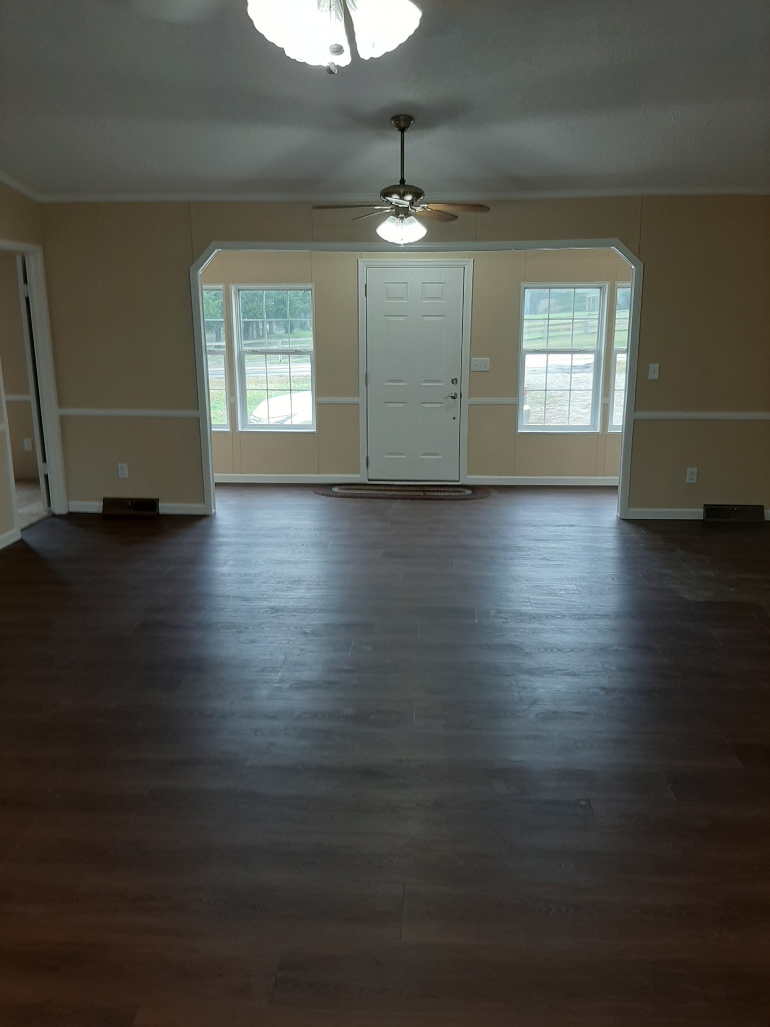4354 Cainsville Road Lebanon, TN 37090 - Photo 8 of 26 an empty room with wooden floor chandelier and windows