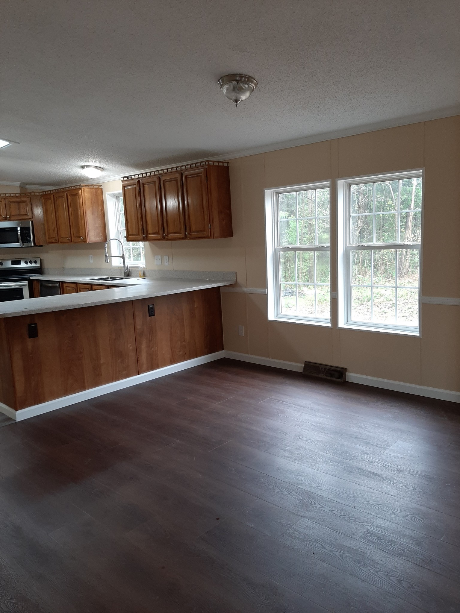 4354 Cainsville Road Lebanon, TN 37090 - Photo 9 of 26 a view of an empty room with wooden floor and a window