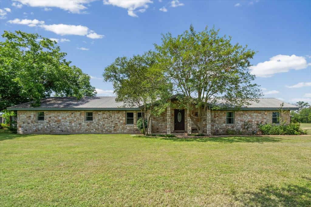 2421 Post Oak Road Webberville, TX 78653 - Photo 2 of 36 Notice how much sprawling green lawn and mature trees you have out here. You are going to love this classic, ranch-style layout.