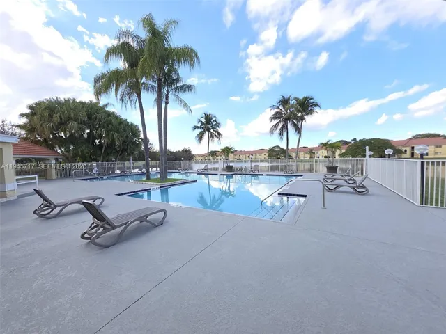 a view of a swimming pool with a table and chairs