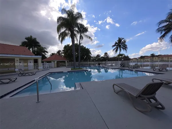 a view of a swimming pool with a table and chairs