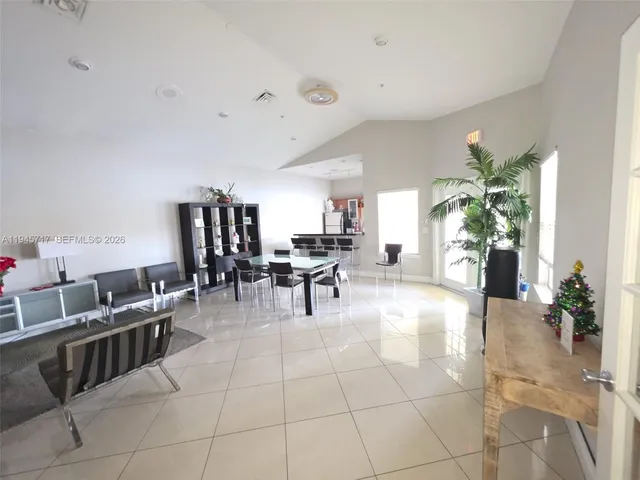 a lobby with furniture and potted plants
