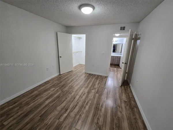 a view of hallway with wooden floor