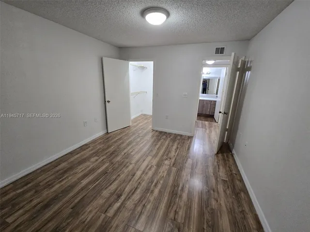 a view of hallway with wooden floor