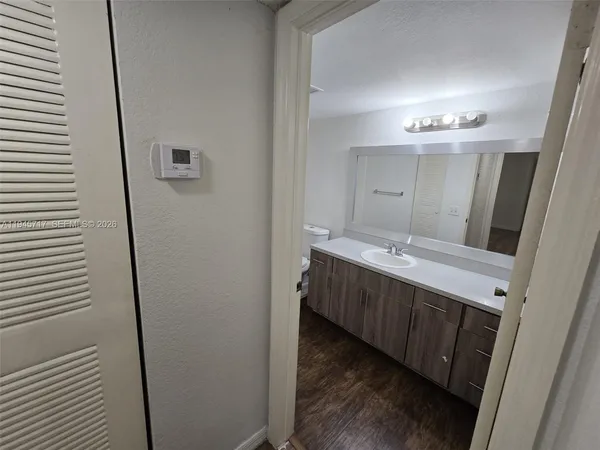 a bathroom with a double vanity sink and mirror