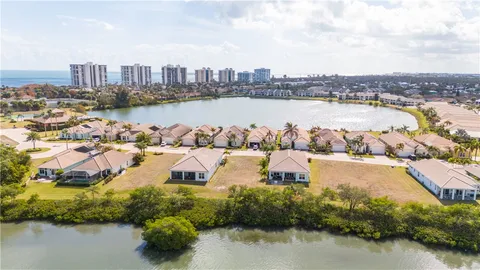 an aerial view of a houses with outdoor space and lake view