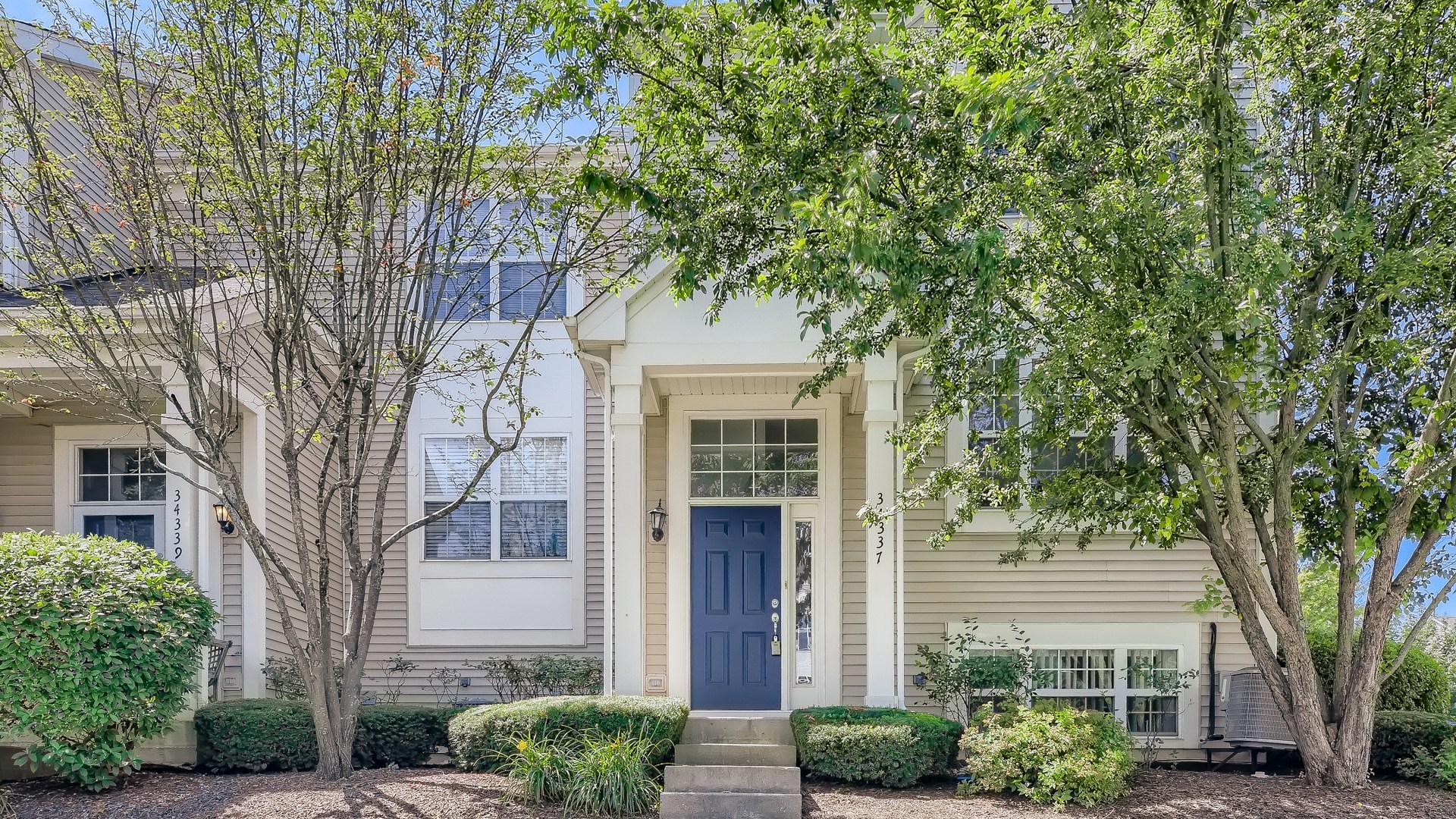 34337 North Barberry Road Round Lake Beach, IL 60073 - Photo 1 of 15 a front view of a house with garden