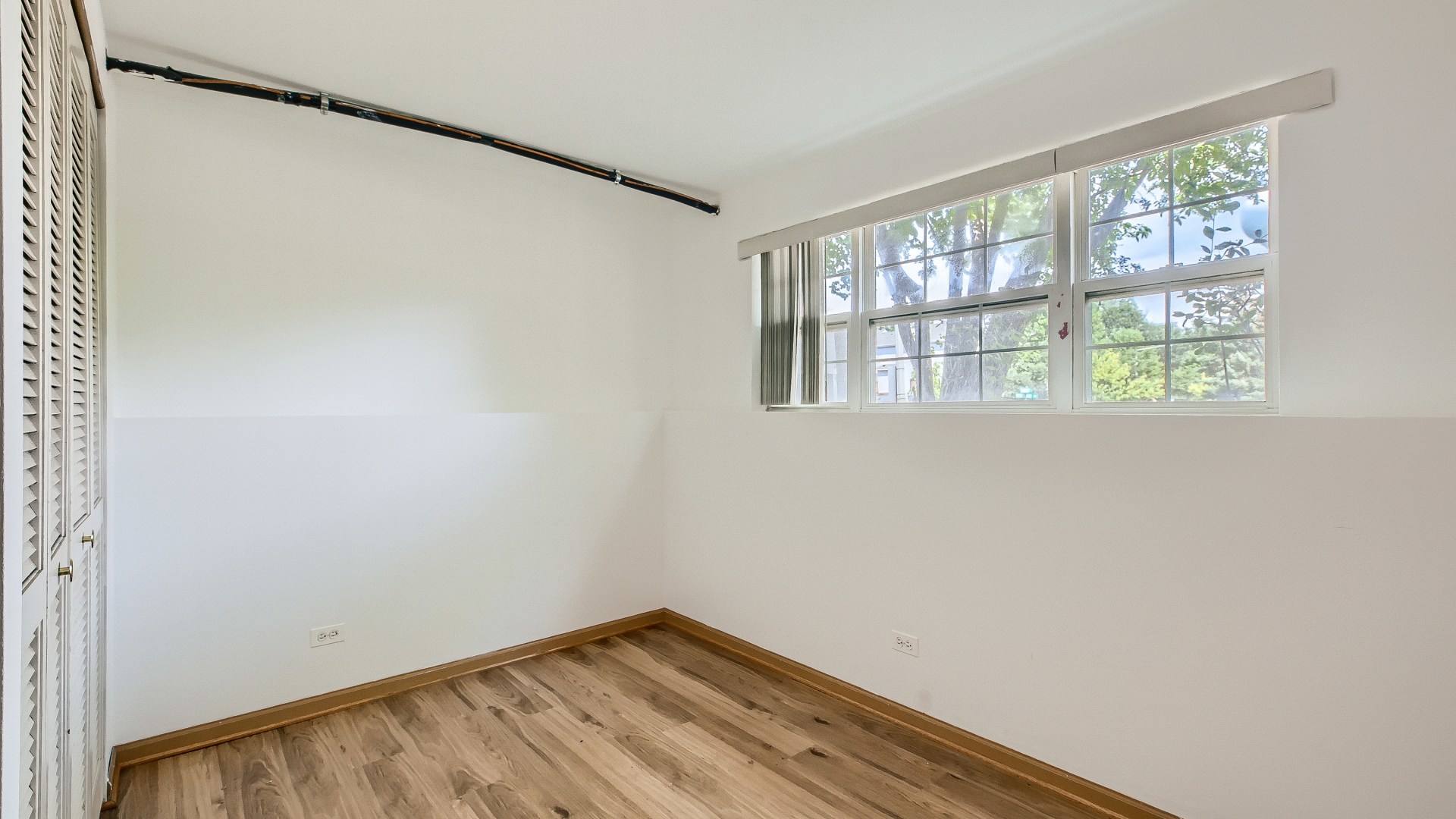 34337 North Barberry Road Round Lake Beach, IL 60073 - Photo 12 of 15 a view of an empty room with wooden floor and a window
