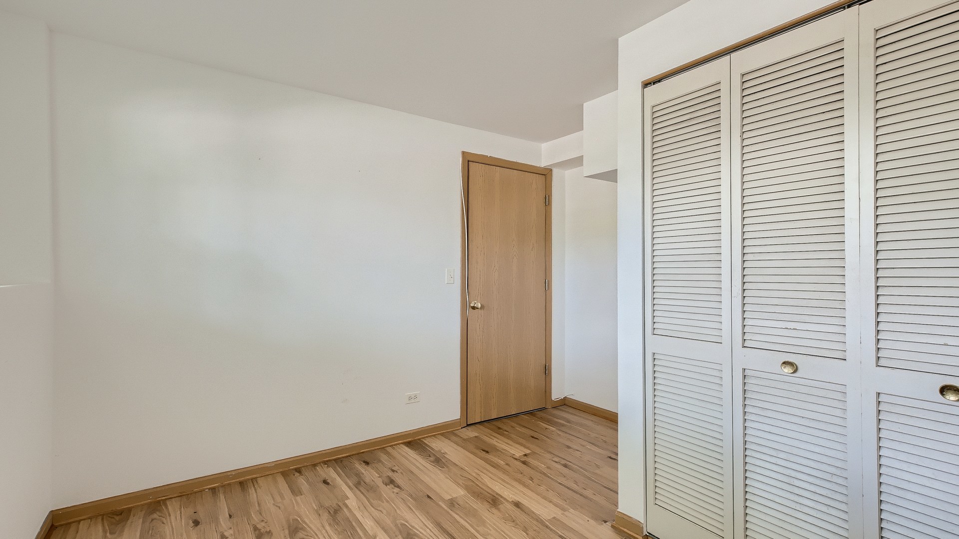 34337 North Barberry Road Round Lake Beach, IL 60073 - Photo 13 of 15 a view of an empty room with wooden floor