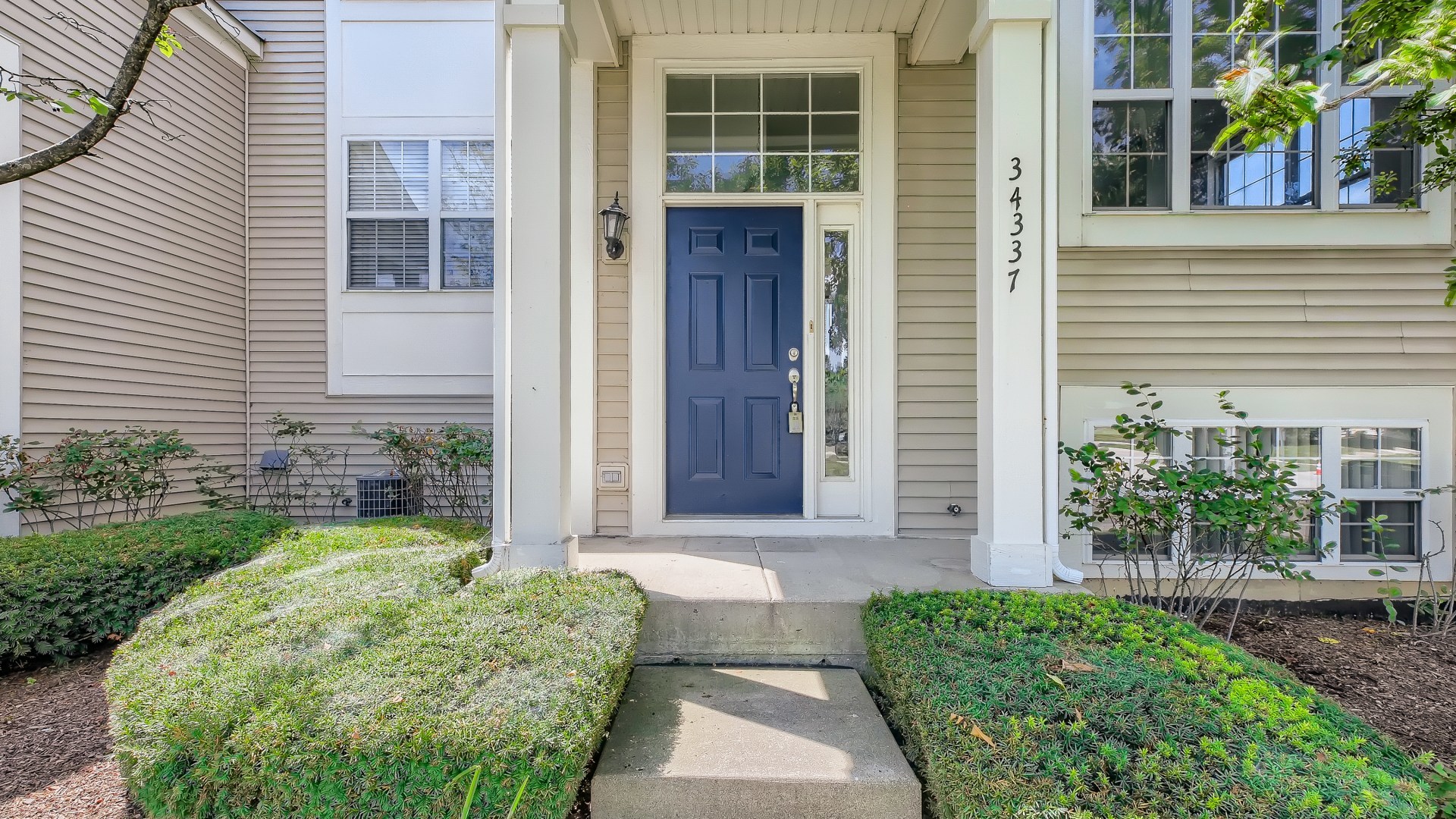 34337 North Barberry Road Round Lake Beach, IL 60073 - Photo 2 of 15 a front view of a house with garden
