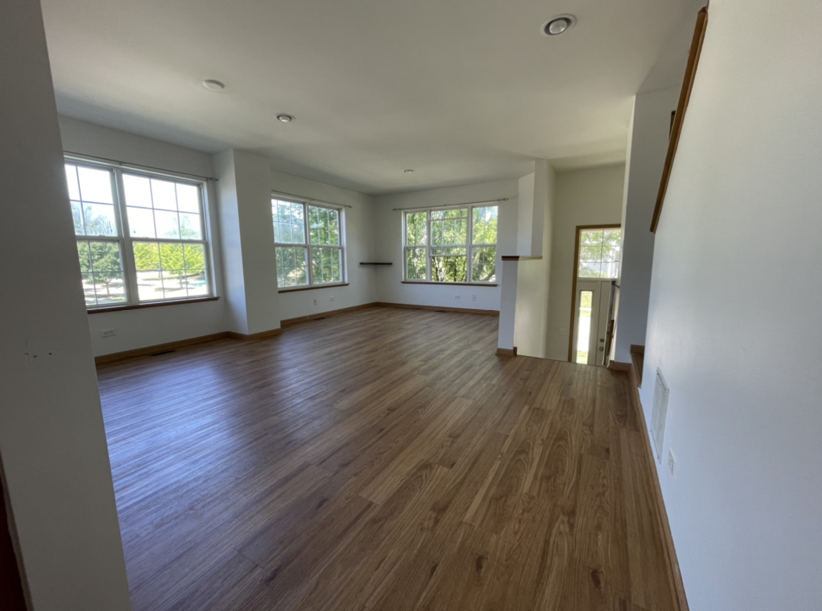 34337 North Barberry Road Round Lake Beach, IL 60073 - Photo 3 of 15 an empty room with wooden floor and windows