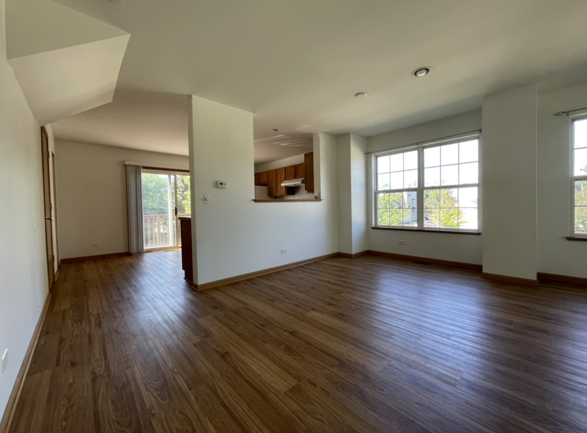 34337 North Barberry Road Round Lake Beach, IL 60073 - Photo 4 of 15 an empty room with wooden floor and windows
