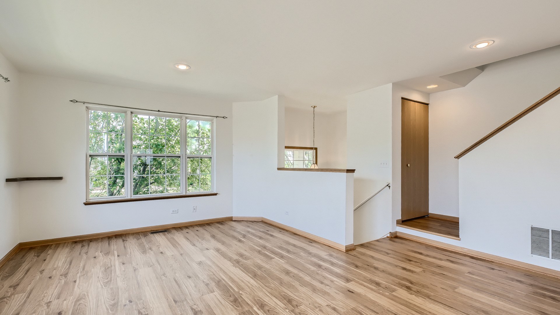 34337 North Barberry Road Round Lake Beach, IL 60073 - Photo 5 of 15 a view of an empty room with wooden floor and a window