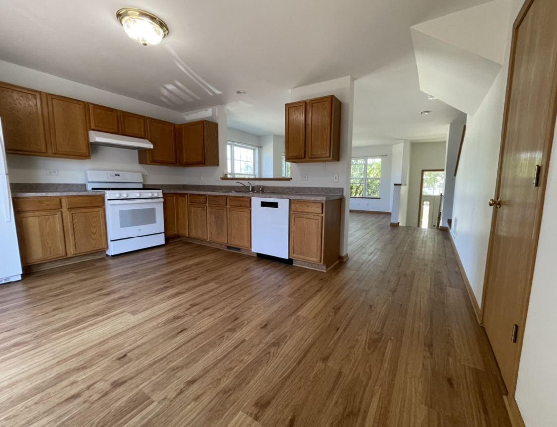 34337 North Barberry Road Round Lake Beach, IL 60073 - Photo 6 of 15 a kitchen with stainless steel appliances wooden floors and refrigerator