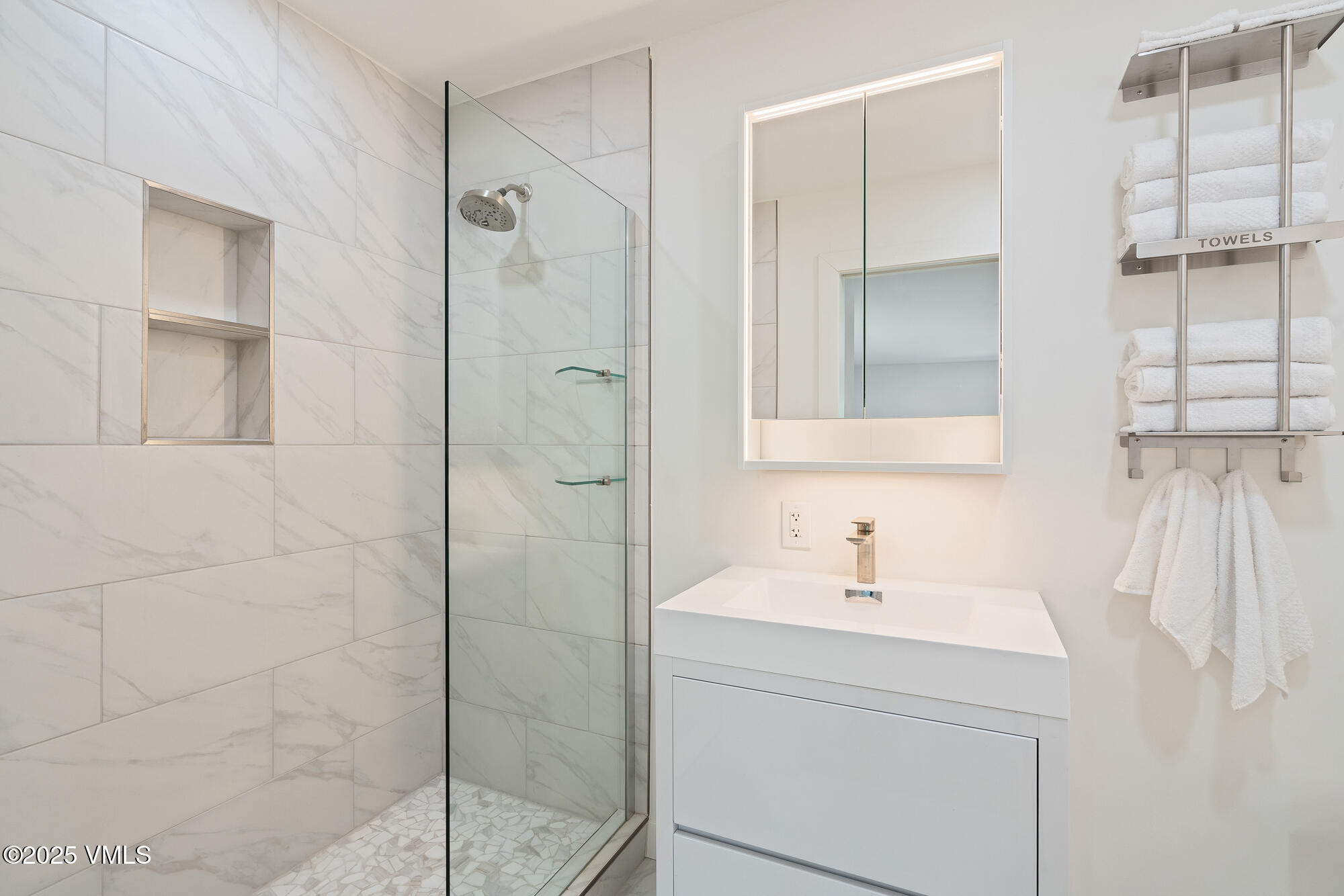 4545 Big Horn Road Vail, CO 81657 - Photo 21 of 49 a bathroom with a shower sink and mirror