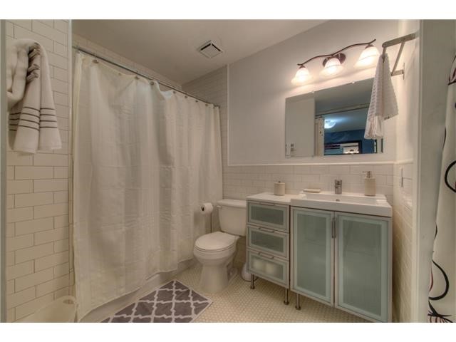 304 East 33rd Street, Unit 2 Austin, TX 78705 - Photo 3 of 12 a bathroom with a sink a toilet and a mirror