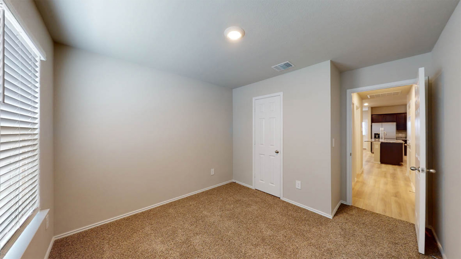 1417 Victory Rnch Trail Killeen, TX 76549 - Photo 13 of 22 A well-lit room with warm carpeting and a view into a contemporary kitchen.