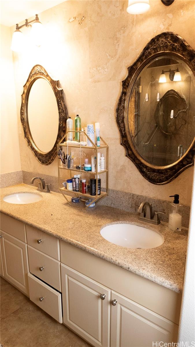 520 Lunalilo Home Road, Unit 7107 Honolulu, HI 96825 - Photo 12 of 21 a bathroom with a granite countertop double vanity sink and a mirror