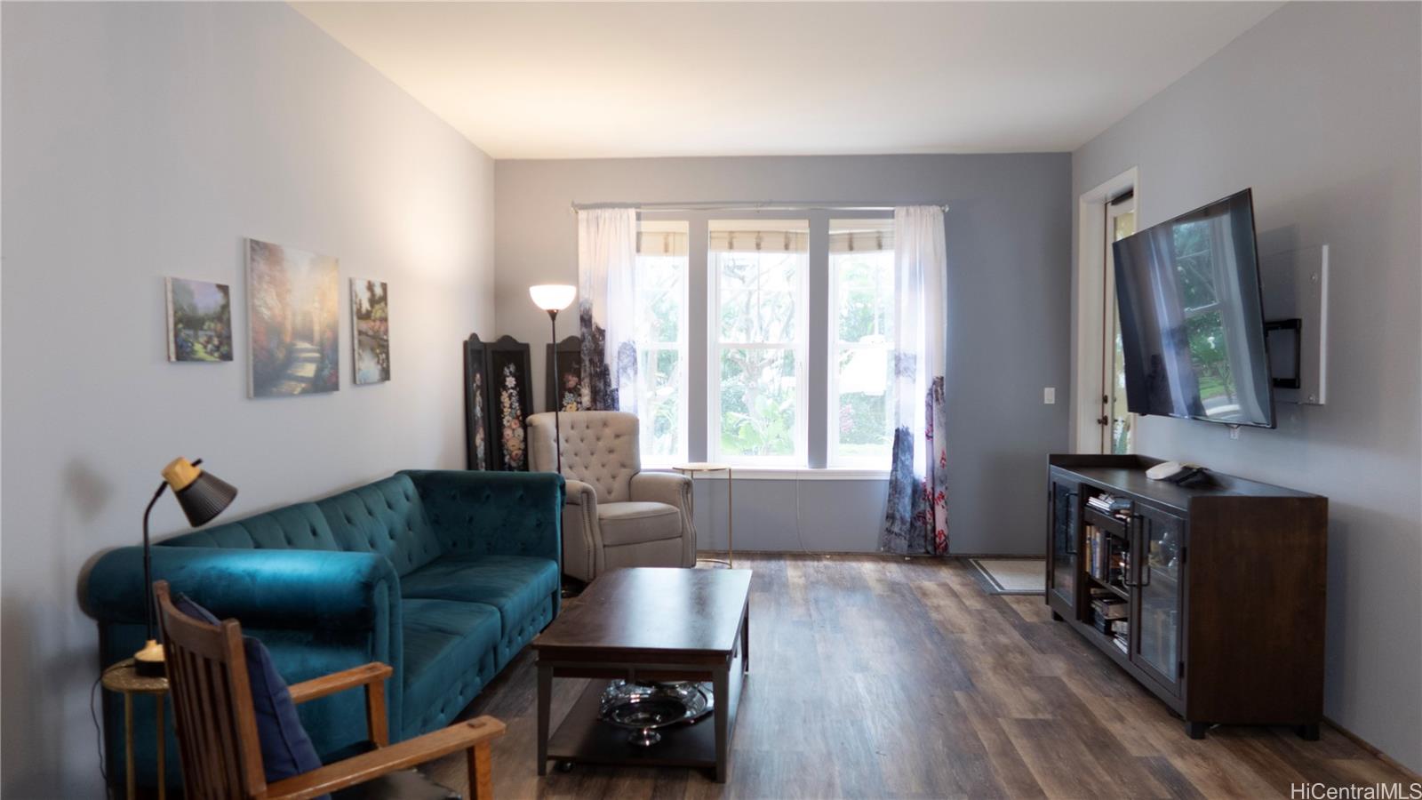 520 Lunalilo Home Road, Unit 7107 Honolulu, HI 96825 - Photo 5 of 21 a living room with furniture and a flat screen tv