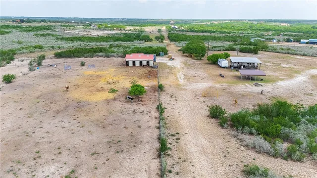 a view of a field with an ocean