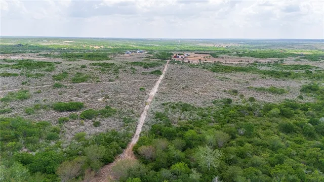a view of a field with an ocean