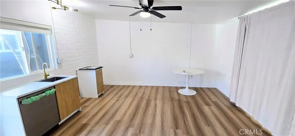 a view of a room with wooden floor and fan