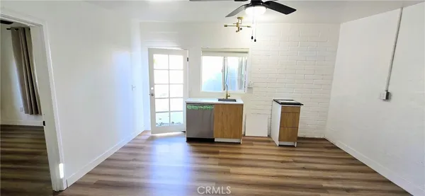 a view of a room with wooden floor and white walls
