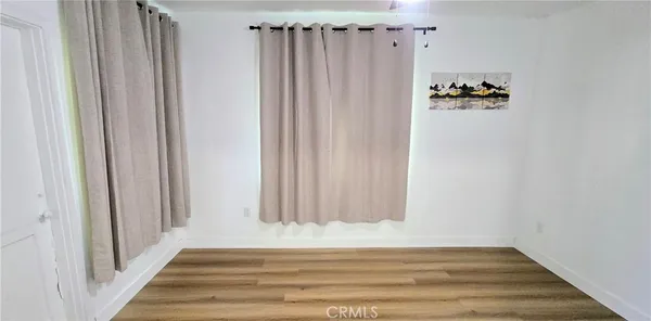 a view of a closet with wooden floor