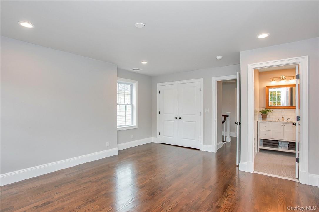 237 Tomahawk Street, Unit 3 Baldwin Place, NY 10505 - Photo 12 of 22 wooden floor in an empty room with a window