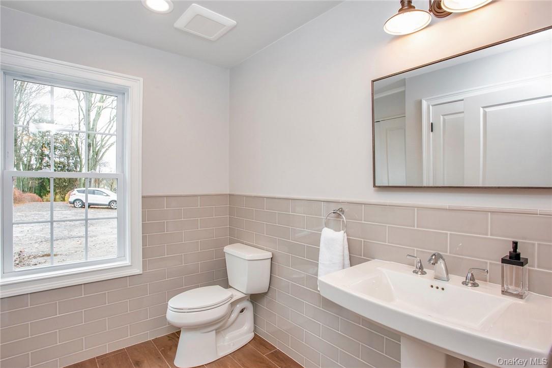 237 Tomahawk Street, Unit 3 Baldwin Place, NY 10505 - Photo 13 of 22 a white toilet sitting next to a bathroom sink