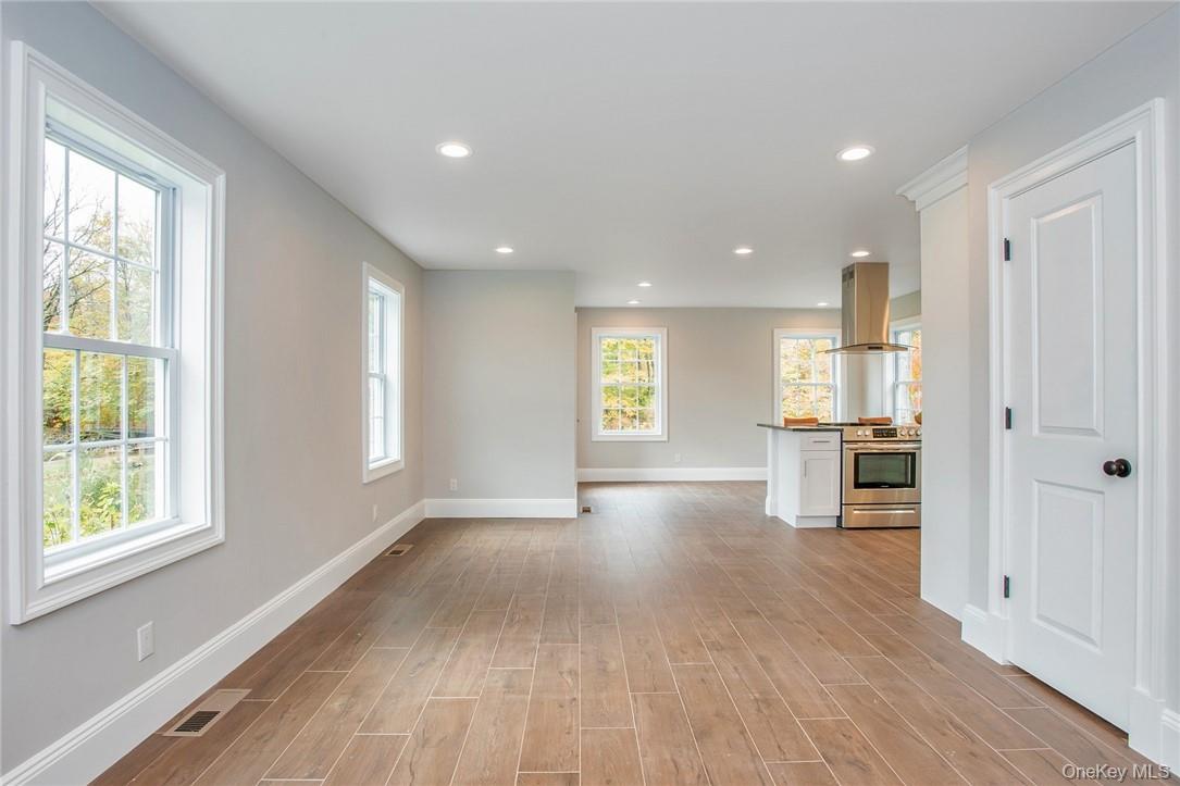 237 Tomahawk Street, Unit 3 Baldwin Place, NY 10505 - Photo 3 of 22 a view of a kitchen with furniture and wooden floor