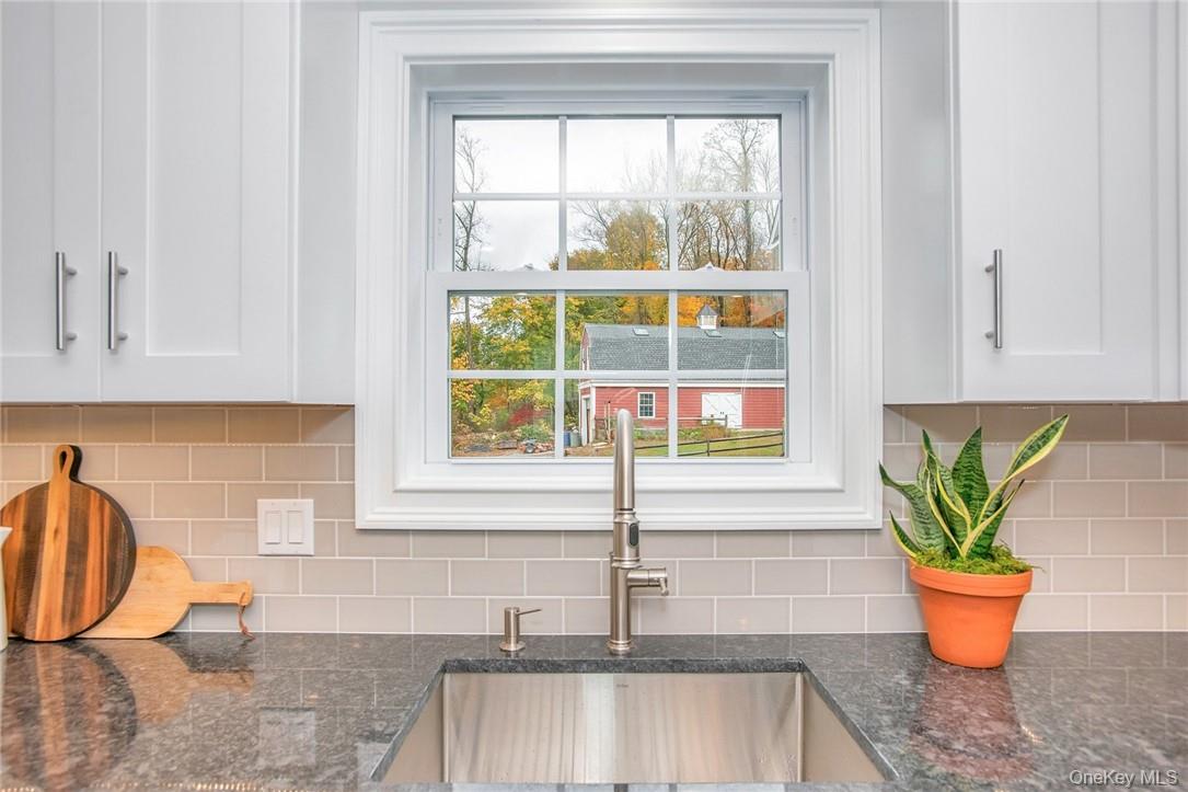 237 Tomahawk Street, Unit 3 Baldwin Place, NY 10505 - Photo 5 of 22 a white painted room with a potted plant and a window