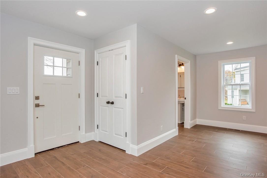 237 Tomahawk Street, Unit 3 Baldwin Place, NY 10505 - Photo 9 of 22 a view of an empty room with wooden floor and a window