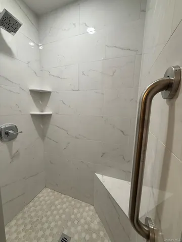 an empty room with a fireplace and windows