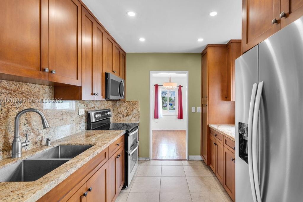 5651 Northwest 3rd Street Miami, FL 33126 - Photo 8 of 21 a kitchen with stainless steel appliances granite countertop a refrigerator and a sink
