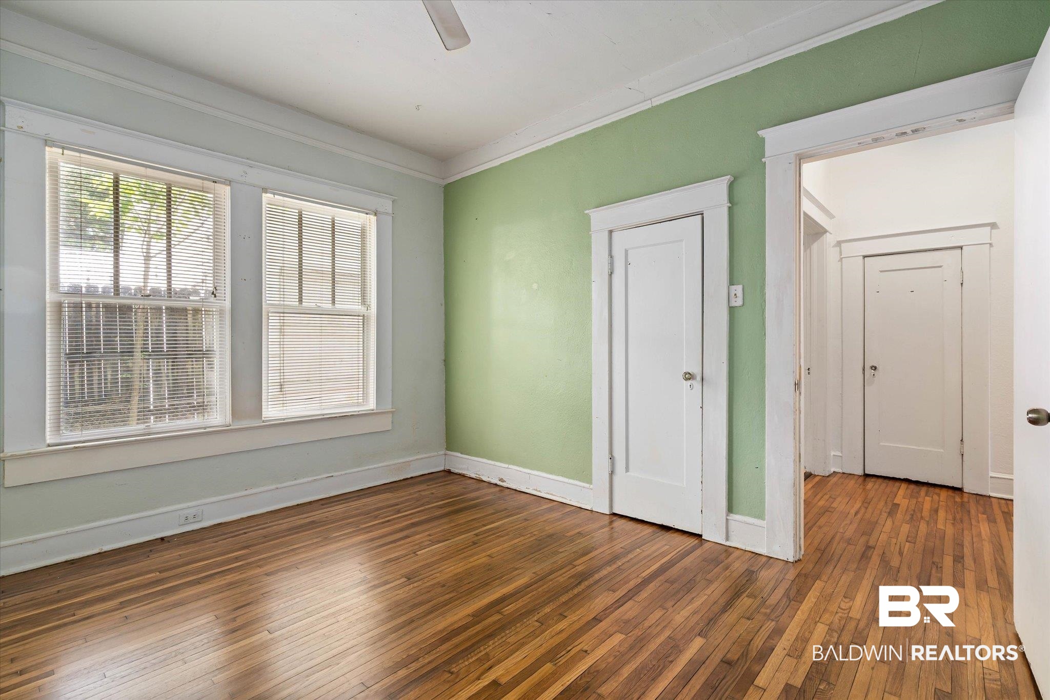 121 Westwood Street Mobile, AL 36606 - Photo 12 of 20 Unfurnished room with crown molding, a ceiling fan, baseboards, and wood-type flooring