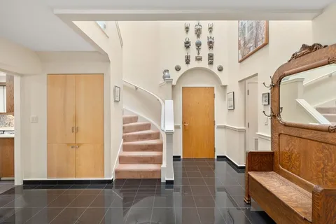 a view of entryway with furniture and wooden floor