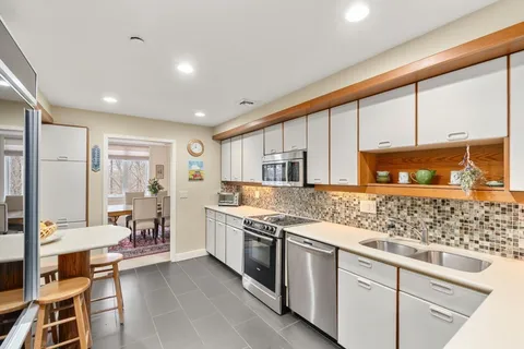 a kitchen with stainless steel appliances granite countertop a stove and more cabinets