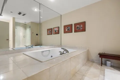 a bathroom with a tub a sink and a shower