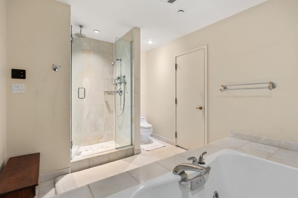 241 Perkins Street, Unit C402 Boston, MA 02130 - Photo 24 of 33 a bathroom with a bathtub and a shower