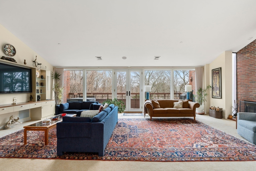 241 Perkins Street, Unit C402 Boston, MA 02130 - Photo 4 of 33 a living room with furniture windows and a flat screen tv
