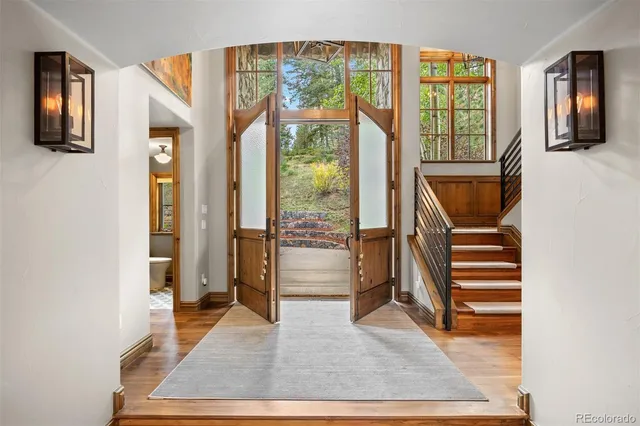 a living room with a balcony furniture and a window