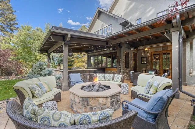 a view of a chairs and table in the back yard