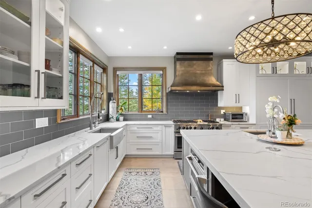 a kitchen with a stove sink and cabinets