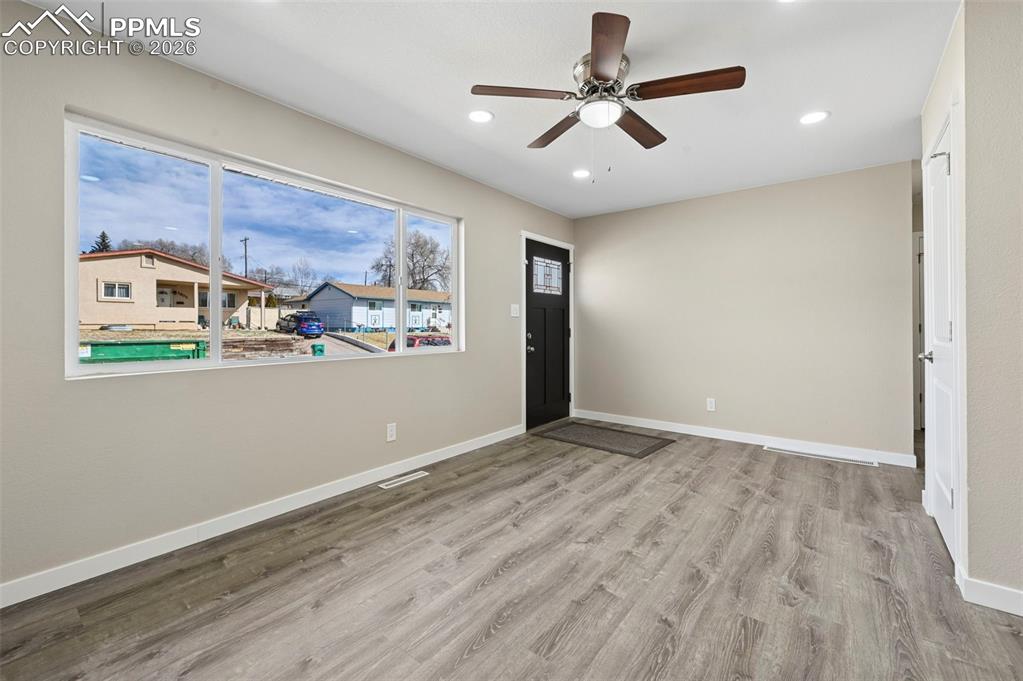 1901 Whitman Road Colorado Springs, CO 80910 - Photo 11 of 35 a view of a livingroom with wooden floor and a ceiling fan
