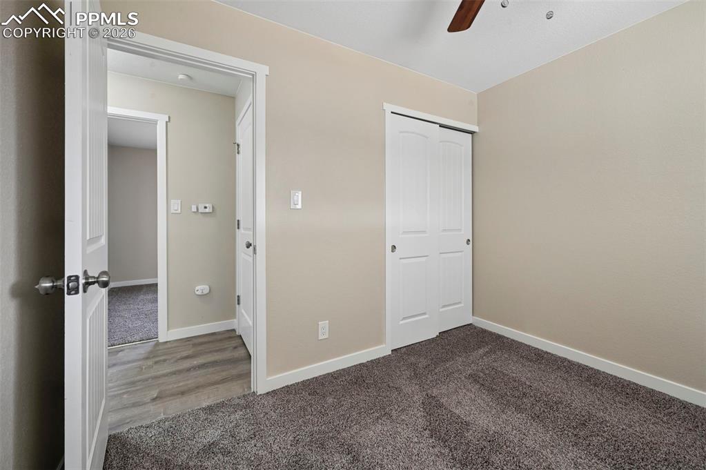 1901 Whitman Road Colorado Springs, CO 80910 - Photo 13 of 35 an empty room with closet and wooden door