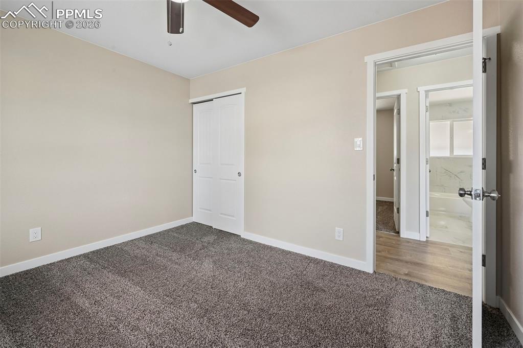 1901 Whitman Road Colorado Springs, CO 80910 - Photo 14 of 35 an empty room with closet and a chandelier fan