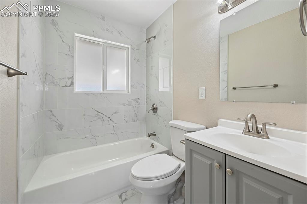 1901 Whitman Road Colorado Springs, CO 80910 - Photo 15 of 35 a bathroom with a sink a toilet and a bathtub