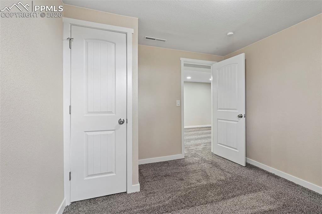 1901 Whitman Road Colorado Springs, CO 80910 - Photo 23 of 35 an empty room with closet and windows